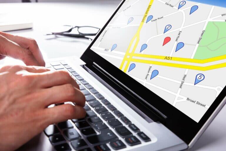 Private investigator tracking GPS vehicle location live on laptop