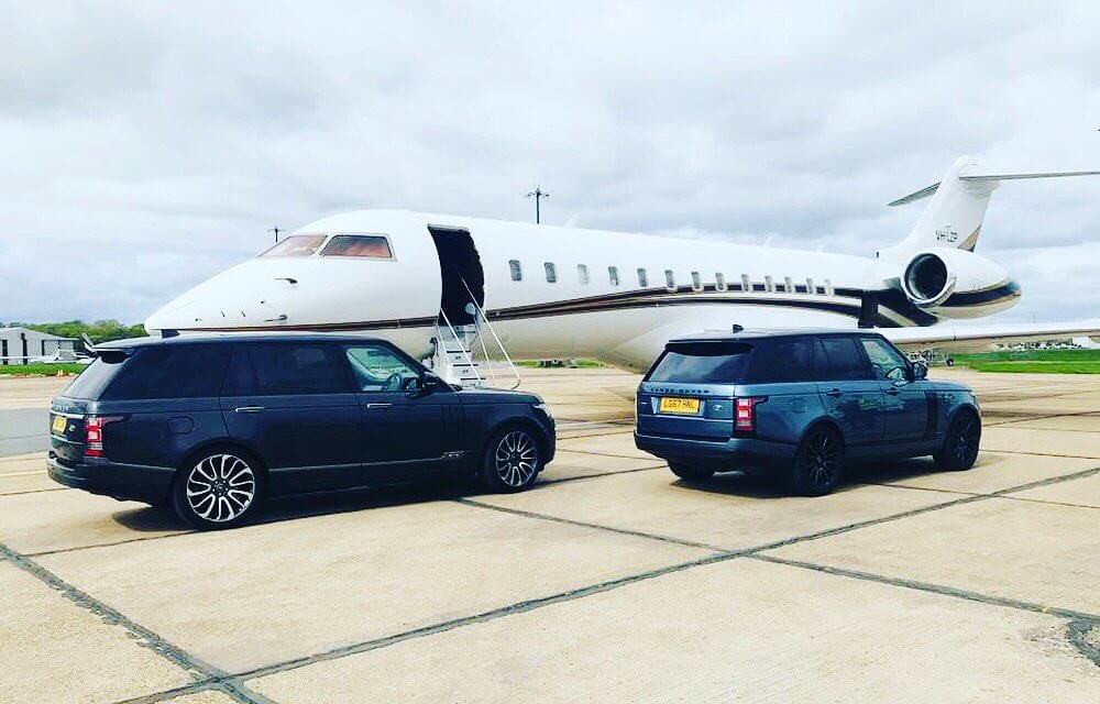 Close protection officer providing discreet security escort for VIP client at a corporate event with a controlled perimeter.